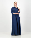 Woman wearing a long blue dress on a white background