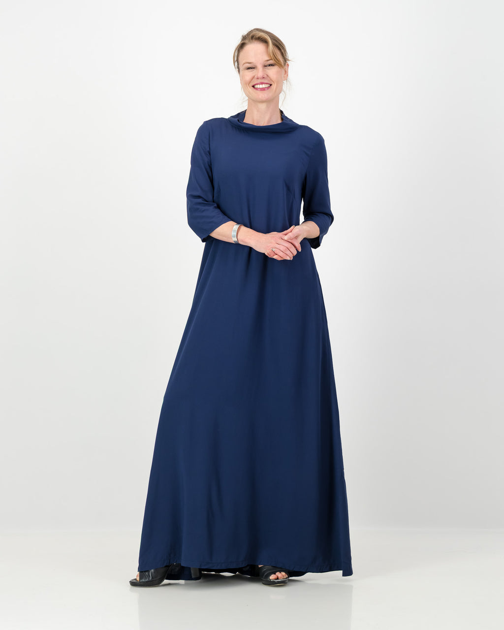 Woman wearing a long blue dress on a white background