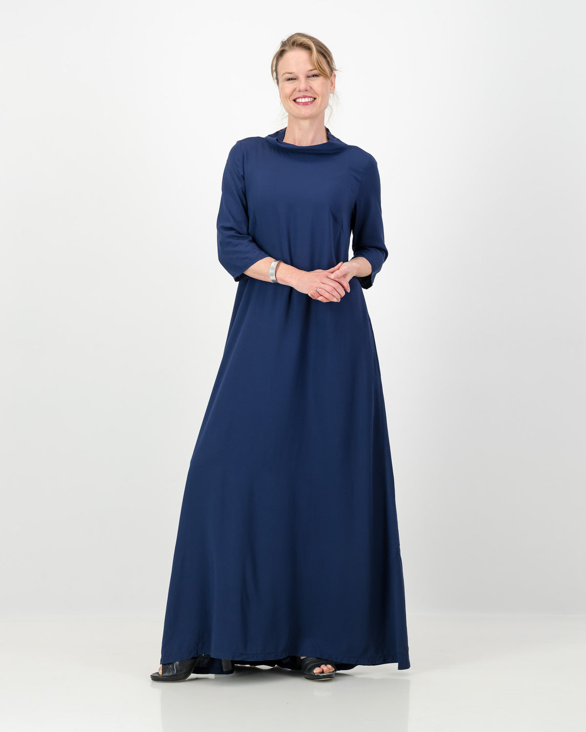 Woman wearing a long blue dress on a white background