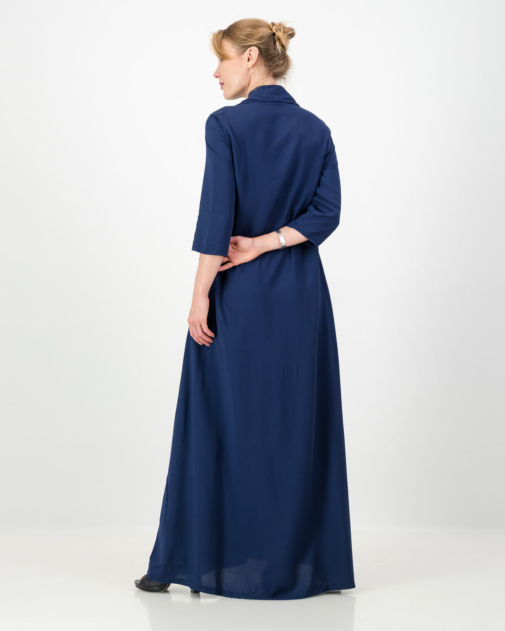 Person wearing a long blue dress on a white background
