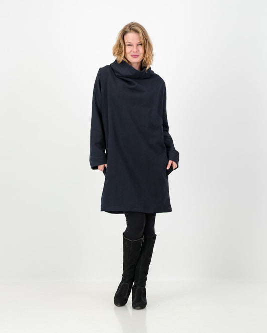 A black-colored winter dress with a cowl neckline, full-length sleeves, and a straight cut, worn by a lady with black boots and leggings.
