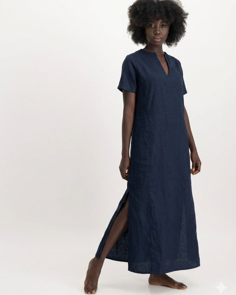 Woman wearing a long navy dress with a V-neck and side slits on a white background