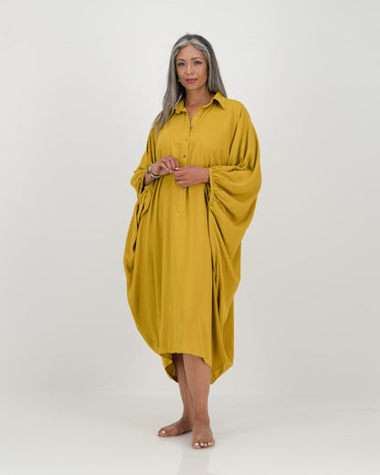 A striking chartreuse kaftan with dramatic batwing sleeve, featuring a relaxed fit, elegant details, and soft draping. Versatile for everyday or belted for a defined shape. Made from eco-friendly rayon.