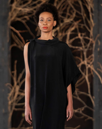 Woman wearing a black LUNAR kari dress. Loose fitting dress on SA Fashion Week runway