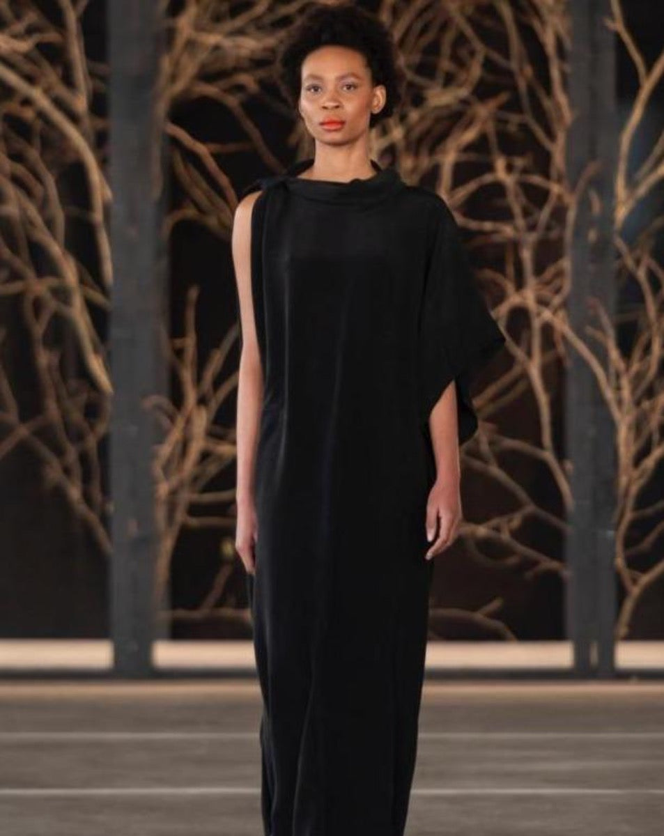 Model wearing a black LUNAR kari dress. Loose fitting dress on SA Fashion Week runway